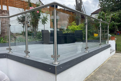 Design ideas for a medium sized modern back partial sun garden for summer in Surrey.