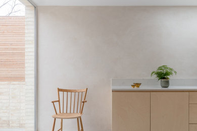 Inspiration for a medium sized scandi l-shaped kitchen/diner in London with an integrated sink, flat-panel cabinets, light wood cabinets, marble worktops, marble splashback, stainless steel appliances, an island, grey floors, white worktops and concrete flooring.