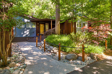 Inspiration for a small 1950s brown one-story mixed siding gable roof remodel