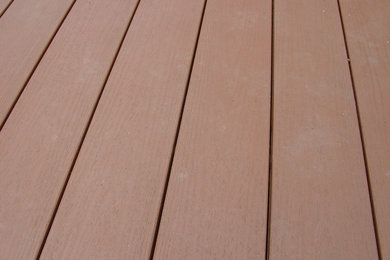 Inspiration for a large contemporary backyard deck remodel in New York with no cover