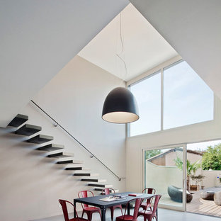 グルノーブルの巨大なコンテンポラリースタイルのLDKの画像 (グレーの壁、コンクリートの床、暖炉なし)