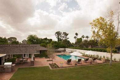 Photo of a farmhouse backyard brick landscaping in Phoenix.