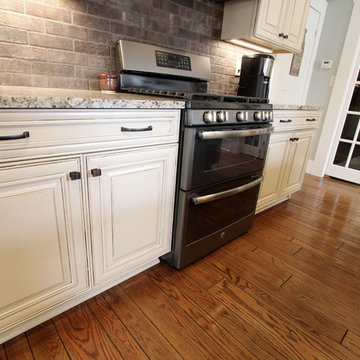 Painted Cream with Brown Glaze Cabinets with Giallo Granite Countertops ~ Sevill