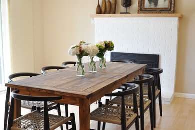 Inspiration for a large timeless light wood floor kitchen/dining room combo remodel in Burlington with beige walls, a standard fireplace and a brick fireplace