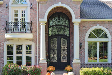 This is an example of a large traditional front door in Other with a double front door and a black front door.
