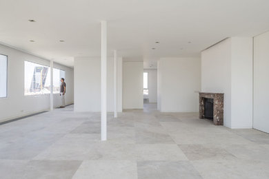 Living room - large contemporary open concept limestone floor and beige floor living room idea in Madrid with white walls, a standard fireplace and a stone fireplace