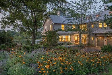 Inspiration for a transitional gray three-story wood house exterior remodel in New York with a shingle roof
