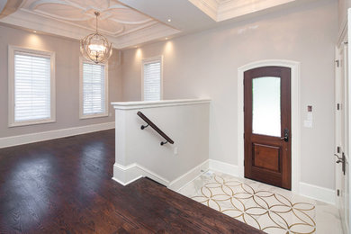 Entryway - transitional dark wood floor and brown floor entryway idea in Toronto with gray walls and a dark wood front door