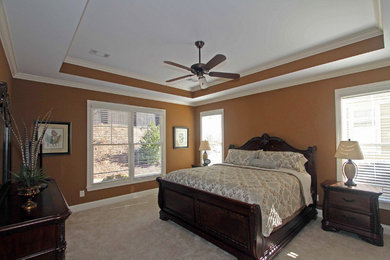 Large elegant master carpeted and beige floor bedroom photo in Columbus with brown walls and no fireplace