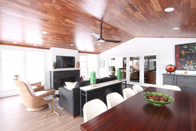Sunroom - large transitional porcelain tile and brown floor sunroom idea in Other with a standard fireplace, a stone fireplace and a standard ceiling