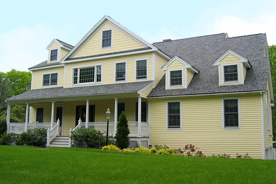 Elegant yellow three-story vinyl exterior home photo in Boston