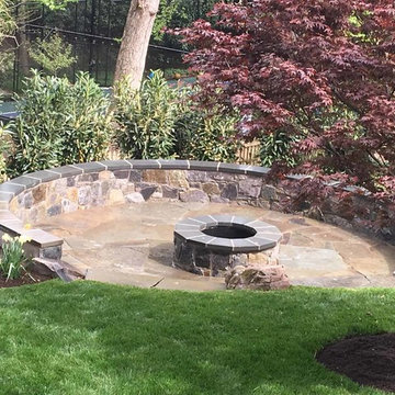Irregular flagstone patio, stone sitting wall, stone firepit