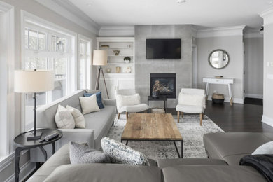 Photo of a modern open plan living room in Vancouver with grey walls, a standard fireplace, a tiled fireplace surround and a wall mounted tv.