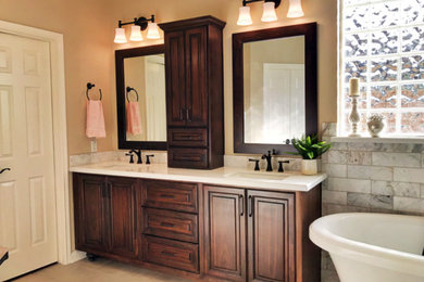 Inspiration for a large timeless master white tile and marble tile porcelain tile and beige floor bathroom remodel in Houston with raised-panel cabinets, dark wood cabinets, beige walls, solid surface countertops, a hinged shower door and white countertops