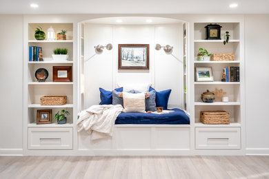 Basement - modern laminate floor and gray floor basement idea in Detroit with white walls