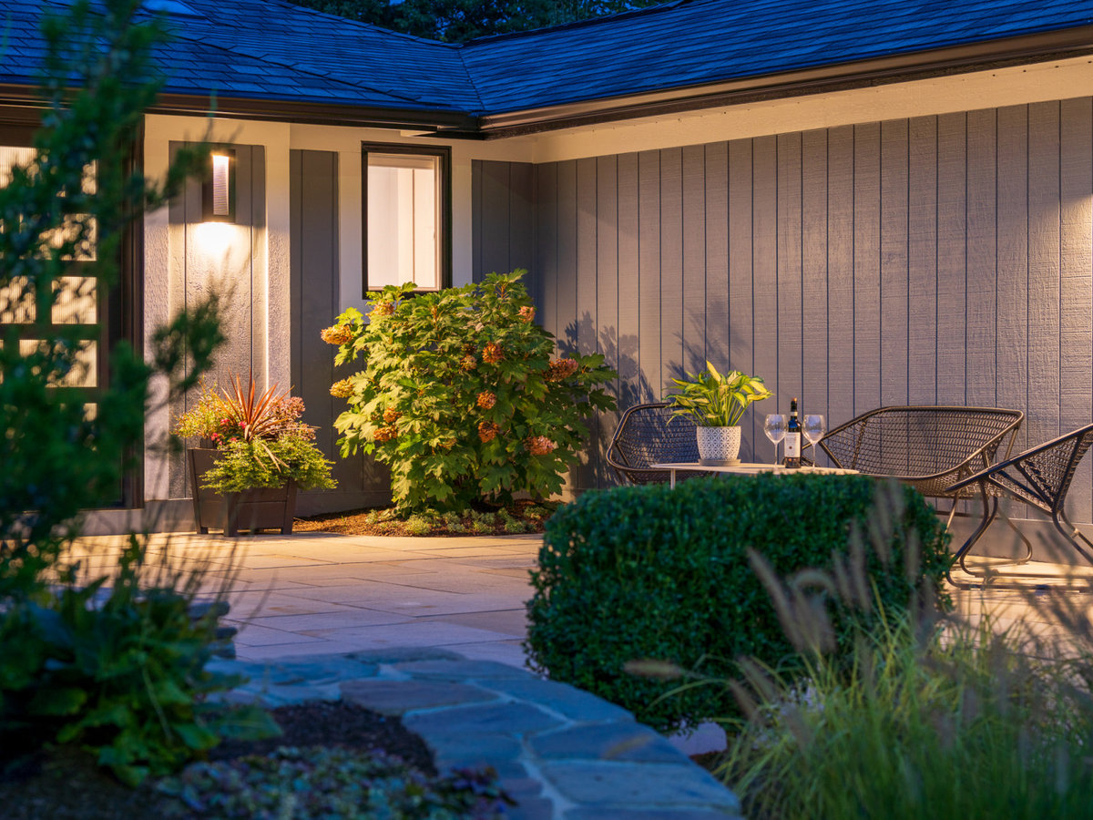 Garden lit front entry at dusk