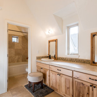 Example of a mid-sized mountain style master beige tile and stone tile bathroom design in Denver with beige cabinets, a one-piece toilet, beige walls, a drop-in sink and granite countertops