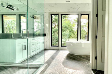 Freestanding bathtub - contemporary master white tile double-sink freestanding bathtub idea with white cabinets, black countertops and a built-in vanity