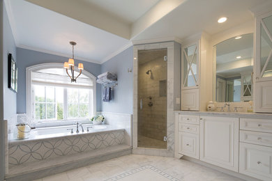 This is an example of a traditional bathroom in Denver with raised-panel cabinets, white cabinets, an alcove tub, a corner shower, a two-piece toilet, white tile, mosaic tile, blue walls, marble floors, an undermount sink and marble benchtops.