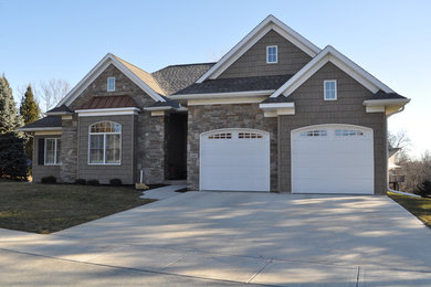 Large traditional gray two-story mixed siding house exterior idea in Cedar Rapids with a hip roof and a shingle roof
