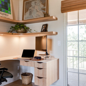 Curved Corner Floating Shelves with Under Cabinet Lighting above Desk