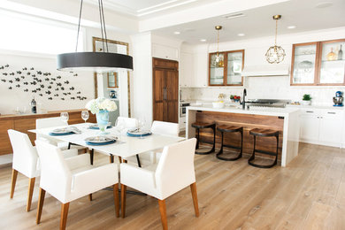 This is an example of a contemporary open plan dining in Orange County with light hardwood floors.