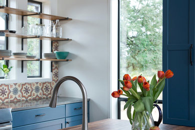 Large cottage galley concrete floor eat-in kitchen photo in Austin with shaker cabinets, blue cabinets, concrete countertops, multicolored backsplash, ceramic backsplash, stainless steel appliances, an island and a farmhouse sink