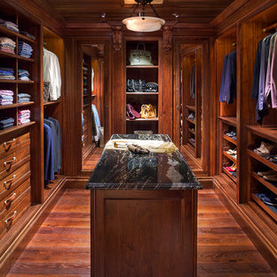 Elegant medium tone wood floor walk-in closet photo in Denver