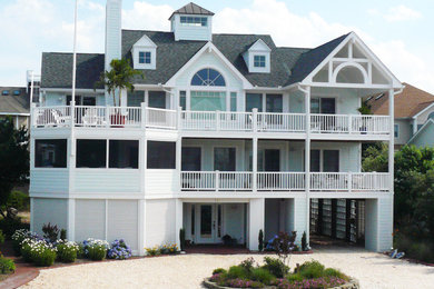 Photo of a mid-sized beach style three-storey blue exterior in Baltimore with wood siding and a gable roof.