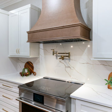 Custom Wood Range Hood with Quartz Backsplash and Brass Pot Filler