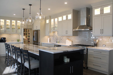 Example of a large transitional l-shaped eat-in kitchen design in Other with shaker cabinets, white cabinets, quartz countertops, white backsplash, stainless steel appliances, an island and gray countertops