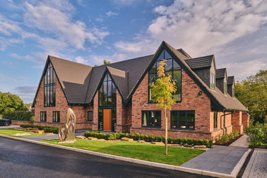 Photo of an expansive and red classic two floor brick detached house in West Midlands with a pitched roof, a shingle roof and a grey roof.
