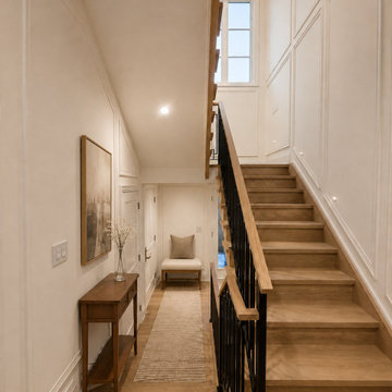 Warm Oak Stair Landing with Custom Wall Moulding