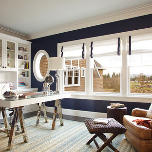 Design ideas for a large nautical home office and library in Portland with blue walls, dark hardwood flooring, a freestanding desk, a two-sided fireplace and a wooden fireplace surround.