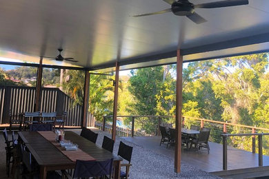 This is an example of a large contemporary backyard patio in Gold Coast - Tweed with decking and a pergola.