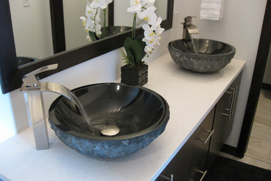 Example of a mid-sized trendy master bathroom design in Phoenix with flat-panel cabinets, dark wood cabinets, a vessel sink and quartzite countertops