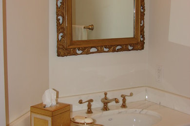 Example of a bathroom design with marble countertops