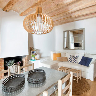 Design ideas for a mediterranean living room in Barcelona with a standard fireplace and a brick fireplace surround.