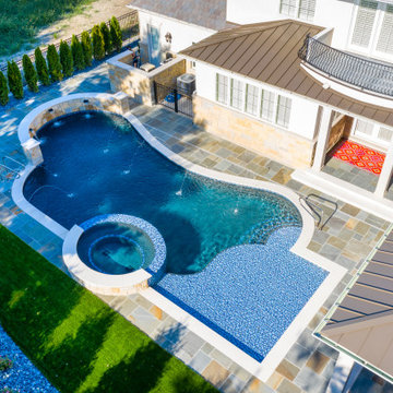 Naperville, IL freeform swimming pool with hot tub, large sunshelf, glass tile