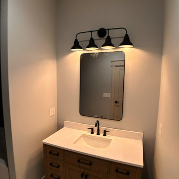 Elegant Guest Bath: Soft Terracotta Walls, Marble Vanity, and Modern Black Fixtu