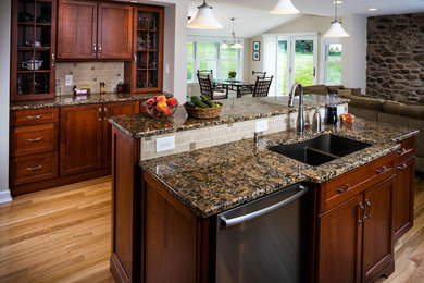 Example of a mid-sized eat-in kitchen design in Other with an undermount sink, granite countertops, beige backsplash and an island