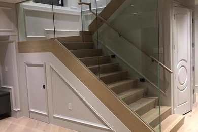 Staircase - large modern wooden u-shaped mixed material railing staircase idea in Vancouver with wooden risers