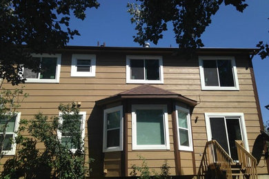 Mid-sized traditional beige two-story vinyl exterior home idea in Denver