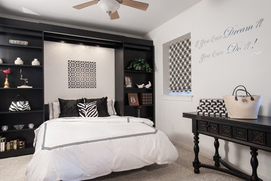 This is an example of a mid-sized contemporary guest bedroom in St Louis with carpet and white walls.