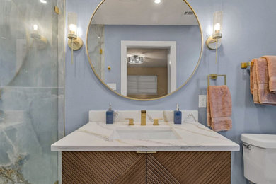 Example of a small minimalist master blue tile and ceramic tile single-sink bathroom design in Dallas with flat-panel cabinets, brown cabinets, a one-piece toilet, blue walls, an undermount sink, quartzite countertops, beige countertops and a floating vanity