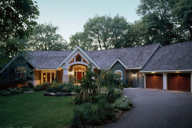 Large traditional two-storey green exterior in Minneapolis with wood siding and a gable roof.