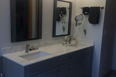 Drop-in bathtub - small transitional master gray tile and porcelain tile porcelain tile drop-in bathtub idea in Other with shaker cabinets, gray cabinets, a two-piece toilet, gray walls, an undermount sink and marble countertops
