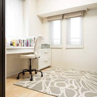 Inspiration for a modern study in Tokyo Suburbs with white walls, plywood flooring, a freestanding desk and beige floors.