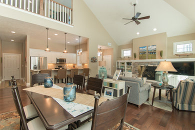 Mid-sized beach style medium tone wood floor great room photo in Milwaukee with beige walls, a standard fireplace and a stone fireplace