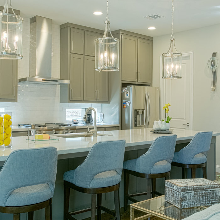 Blue bar stools add to the cohesive look of blue accents for the shared spaces of kitchen, breakfast room and family room.